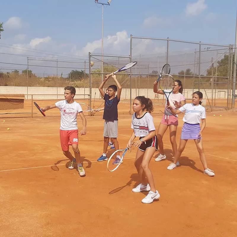 Entrenamiento de tenis en tierra batida durante el campus
